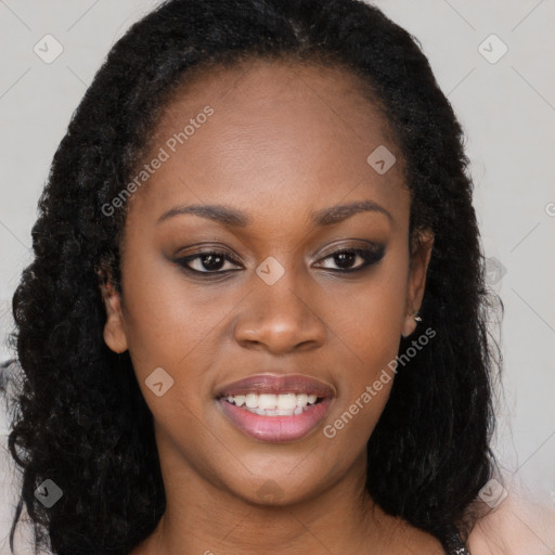 Joyful black young-adult female with long  brown hair and brown eyes