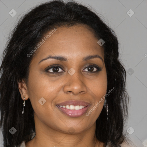 Joyful black young-adult female with long  brown hair and brown eyes