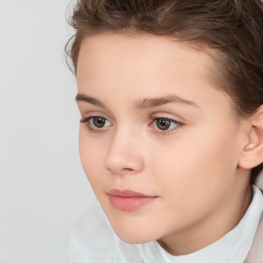 Joyful white child female with short  brown hair and brown eyes