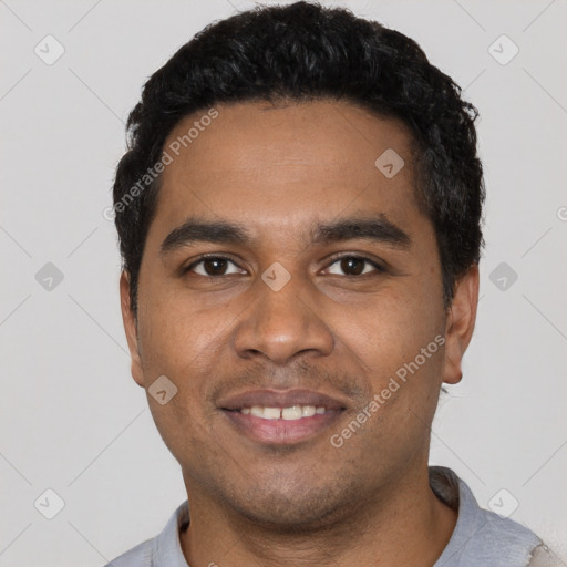 Joyful black young-adult male with short  black hair and brown eyes