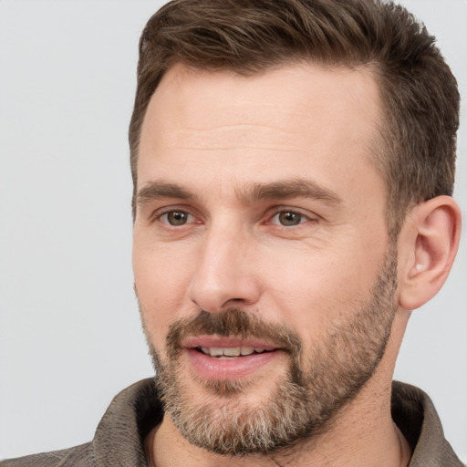 Joyful white adult male with short  brown hair and brown eyes