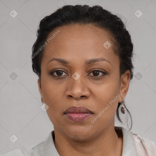 Joyful black adult female with short  brown hair and brown eyes