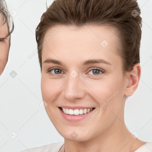 Joyful white young-adult female with short  brown hair and grey eyes