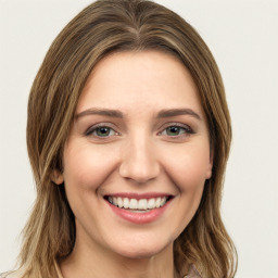 Joyful white young-adult female with long  brown hair and green eyes