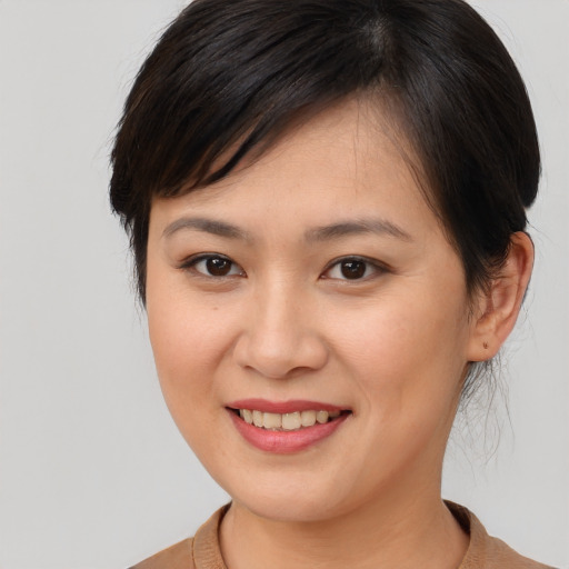 Joyful white young-adult female with medium  brown hair and brown eyes