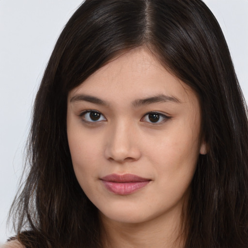 Joyful asian young-adult female with long  brown hair and brown eyes