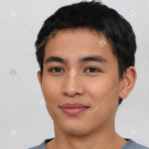 Joyful asian young-adult male with short  black hair and brown eyes