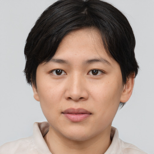 Joyful asian young-adult female with medium  brown hair and brown eyes