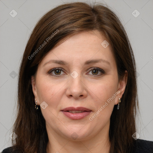 Joyful white adult female with long  brown hair and brown eyes