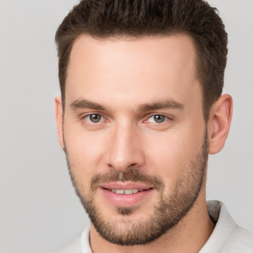 Joyful white young-adult male with short  brown hair and brown eyes