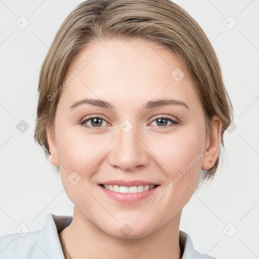 Joyful white young-adult female with medium  brown hair and grey eyes