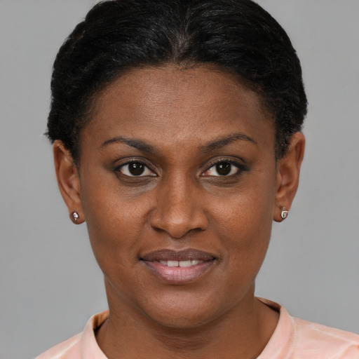 Joyful black young-adult female with short  brown hair and brown eyes