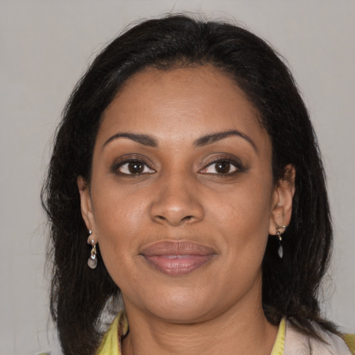 Joyful black young-adult female with medium  brown hair and brown eyes