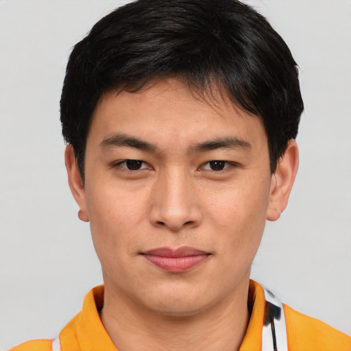 Joyful asian young-adult male with short  brown hair and brown eyes
