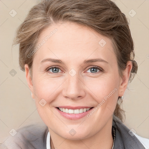 Joyful white young-adult female with medium  brown hair and grey eyes