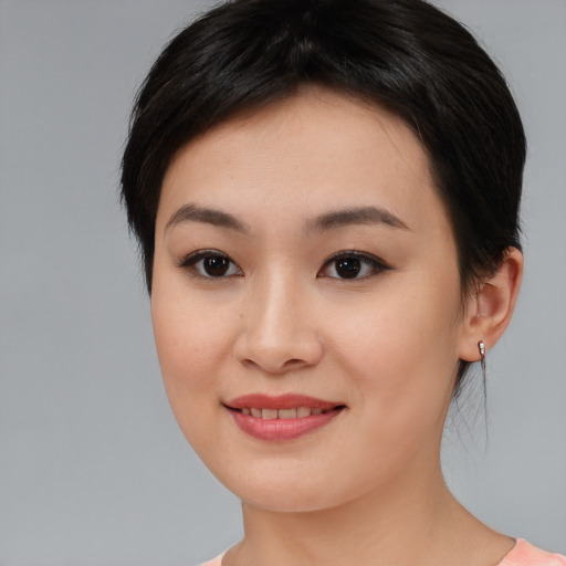 Joyful asian young-adult female with medium  black hair and brown eyes