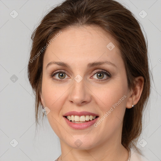 Joyful white young-adult female with medium  brown hair and green eyes