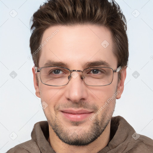 Joyful white adult male with short  brown hair and grey eyes