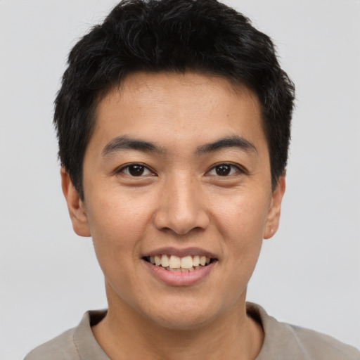 Joyful asian young-adult male with short  black hair and brown eyes