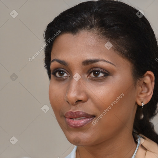 Joyful black young-adult female with medium  brown hair and brown eyes