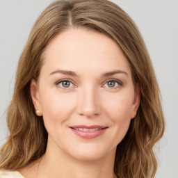 Joyful white young-adult female with medium  brown hair and green eyes