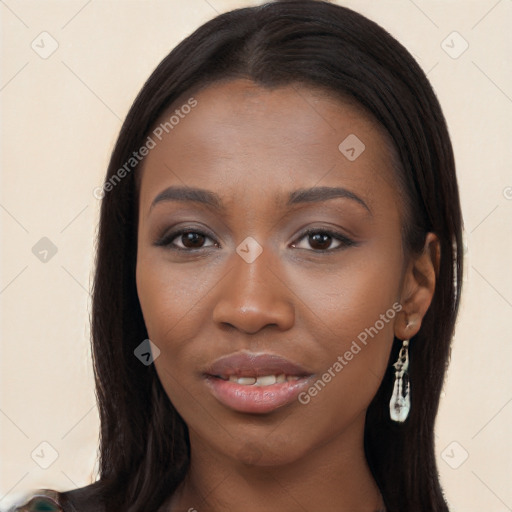 Joyful black young-adult female with long  black hair and brown eyes