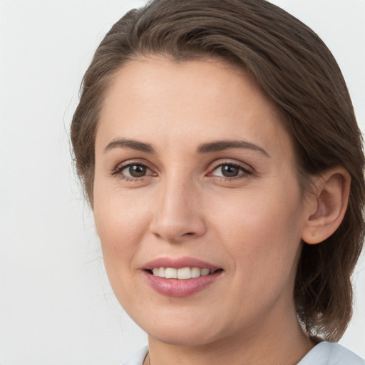 Joyful white young-adult female with medium  brown hair and grey eyes