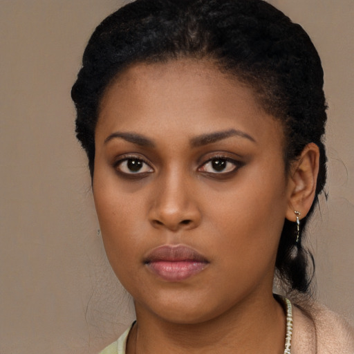 Neutral black young-adult female with medium  brown hair and brown eyes