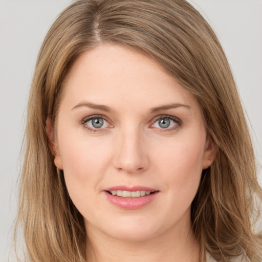 Joyful white young-adult female with long  brown hair and grey eyes