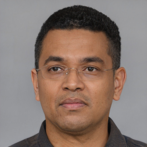 Neutral latino adult male with short  black hair and brown eyes