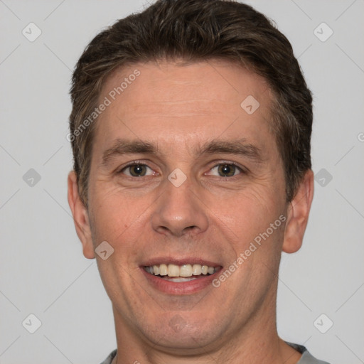 Joyful white adult male with short  brown hair and brown eyes