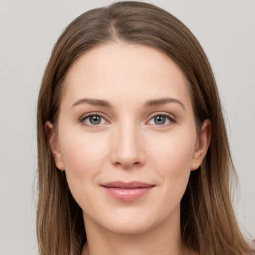 Joyful white young-adult female with long  brown hair and grey eyes