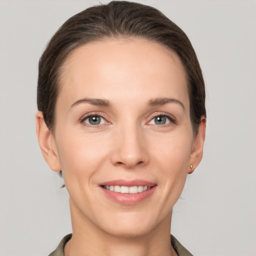 Joyful white young-adult female with short  brown hair and grey eyes