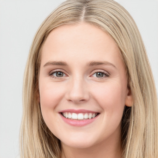 Joyful white young-adult female with long  brown hair and grey eyes