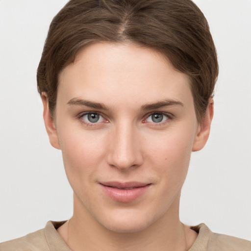 Joyful white young-adult female with short  brown hair and grey eyes