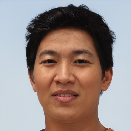 Joyful asian adult female with short  brown hair and brown eyes
