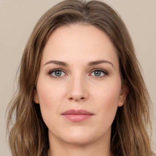 Joyful white young-adult female with long  brown hair and green eyes