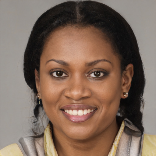 Joyful black young-adult female with medium  brown hair and brown eyes