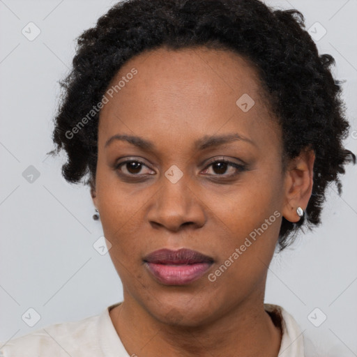 Joyful black adult female with short  brown hair and brown eyes