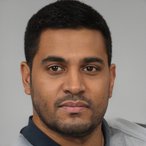 Neutral latino young-adult male with short  black hair and brown eyes