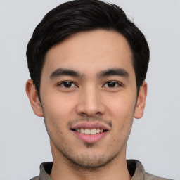 Joyful asian young-adult male with short  black hair and brown eyes