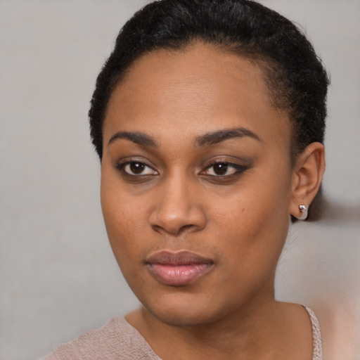 Joyful black young-adult female with short  black hair and brown eyes