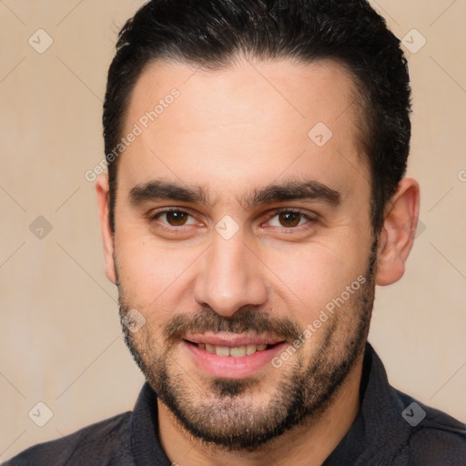 Joyful white young-adult male with short  black hair and brown eyes