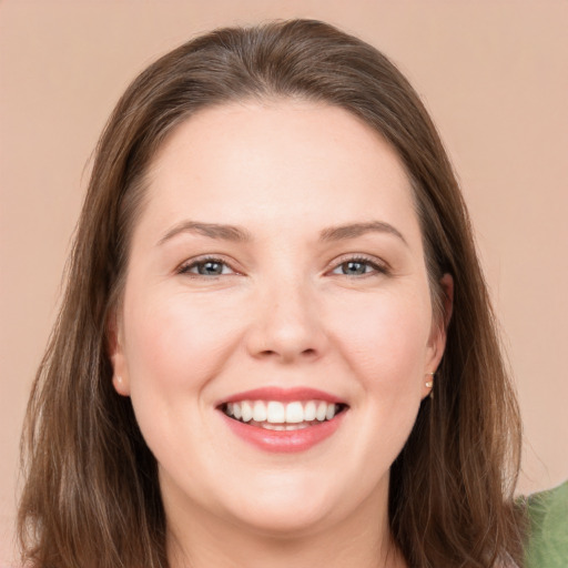 Joyful white young-adult female with long  brown hair and brown eyes