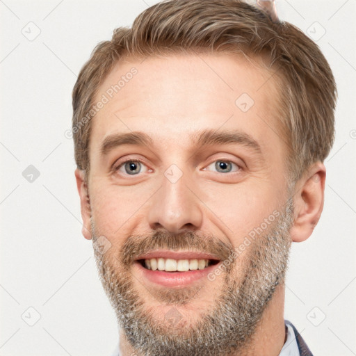 Joyful white adult male with short  brown hair and grey eyes