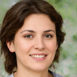 Joyful white young-adult female with medium  brown hair and green eyes