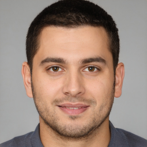 Joyful white young-adult male with short  brown hair and brown eyes