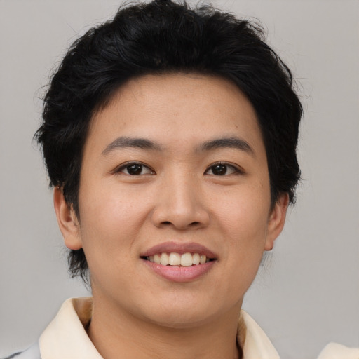 Joyful asian young-adult female with short  black hair and brown eyes