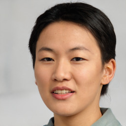 Joyful asian young-adult female with short  brown hair and brown eyes