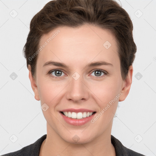 Joyful white young-adult female with short  brown hair and grey eyes